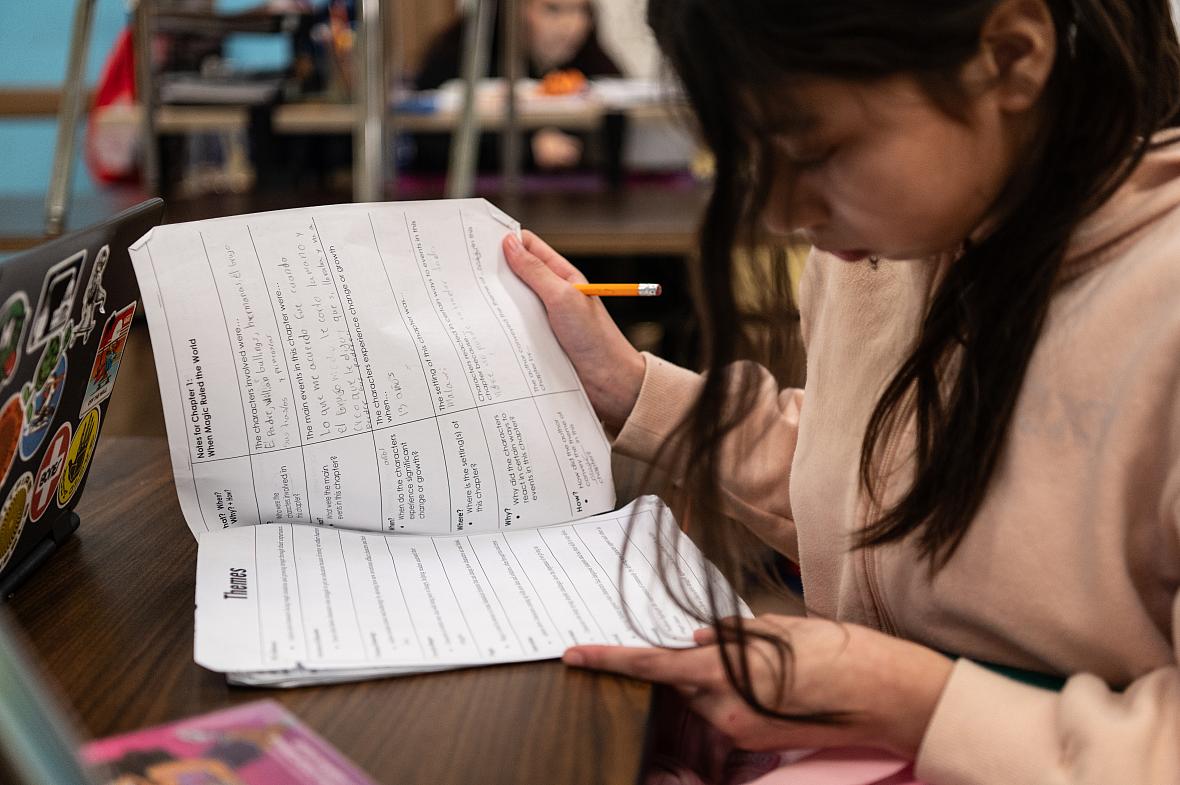 Child looking at notes