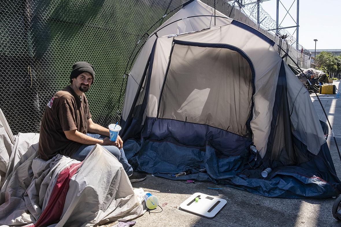 Person sitting in front of a tent