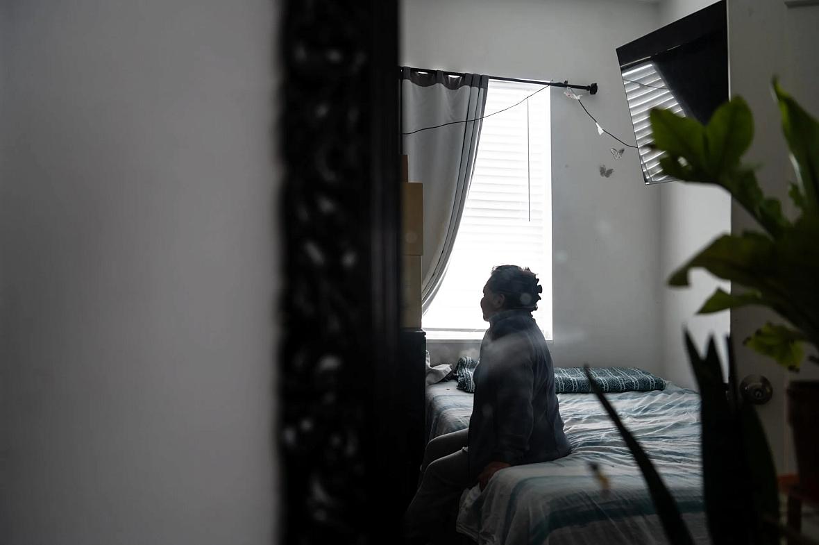 Woman sitting on bed