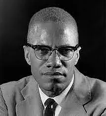 Non-colored picture depicting a person in a suit and glasses with a tie