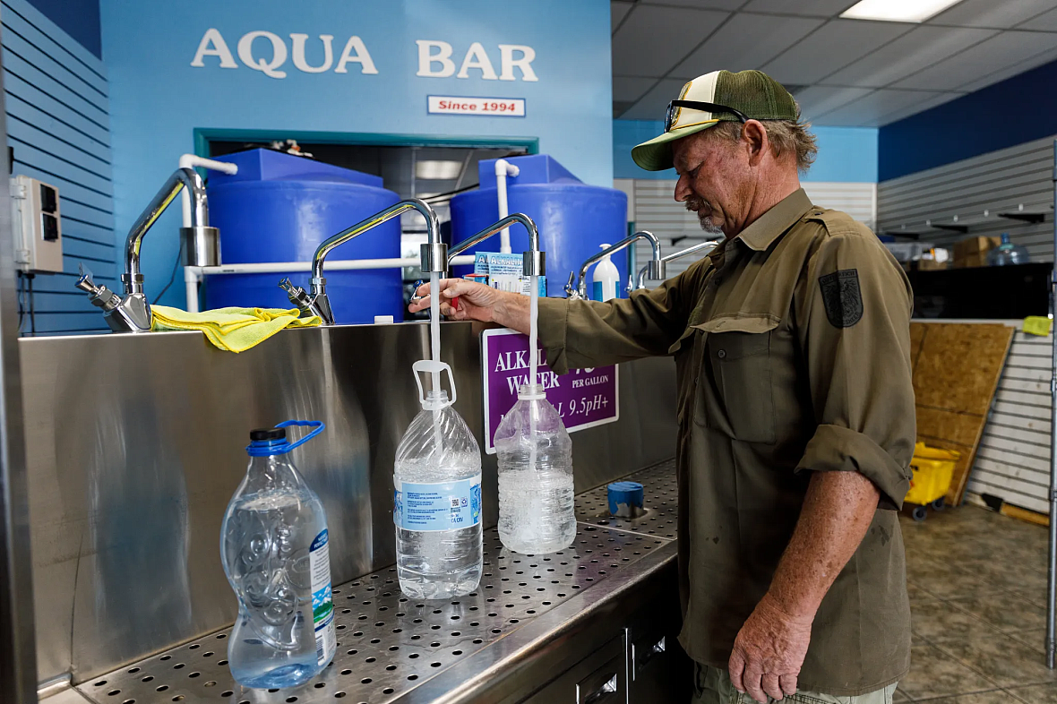 Person filling bottles with water