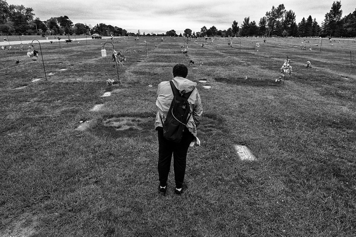 Black and white picture of a person in a graveyard