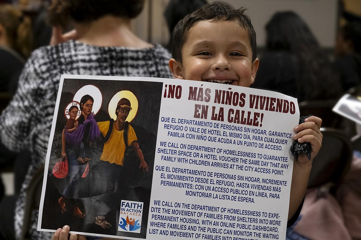 child holding poster