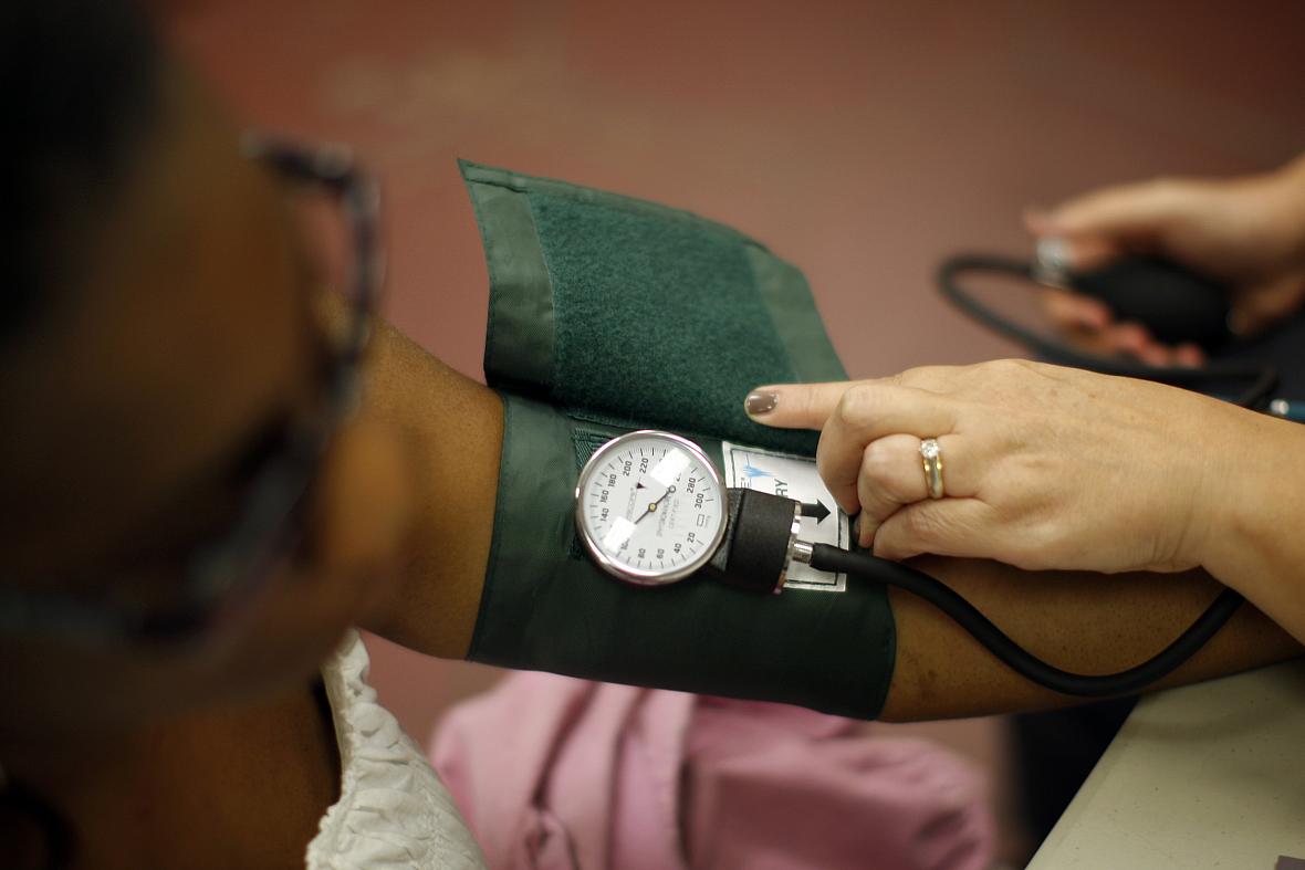 A woman has her blood pressure taken.