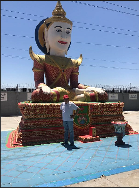 Person standing in front of a large statue