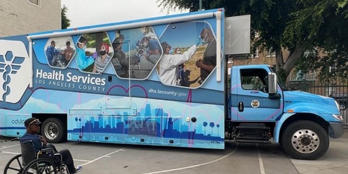 A Black man in a wheelchair waits to be seen at a mobile clinic in the Central Valley. 