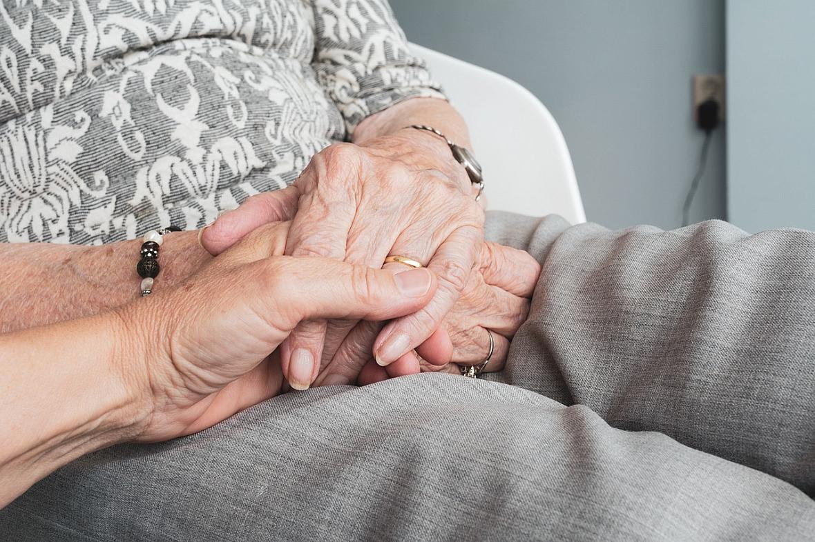 Hands held together in someone's lap