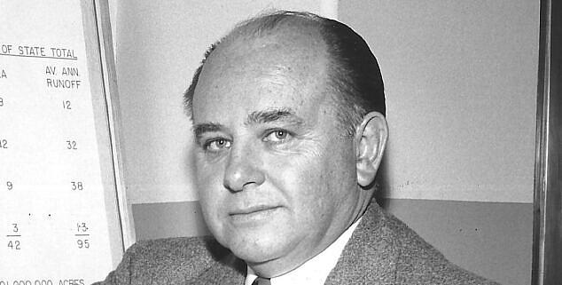 Black and white picture of a person wearing a suit