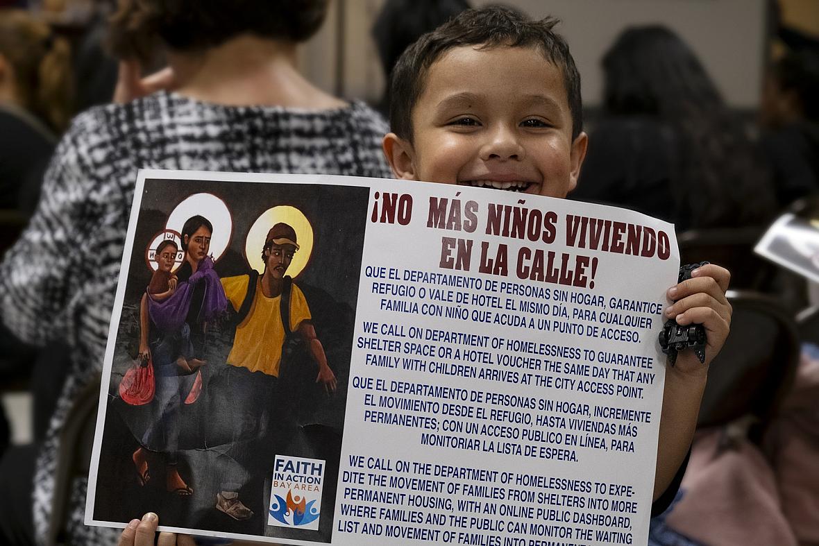 Image of a child holding a banner