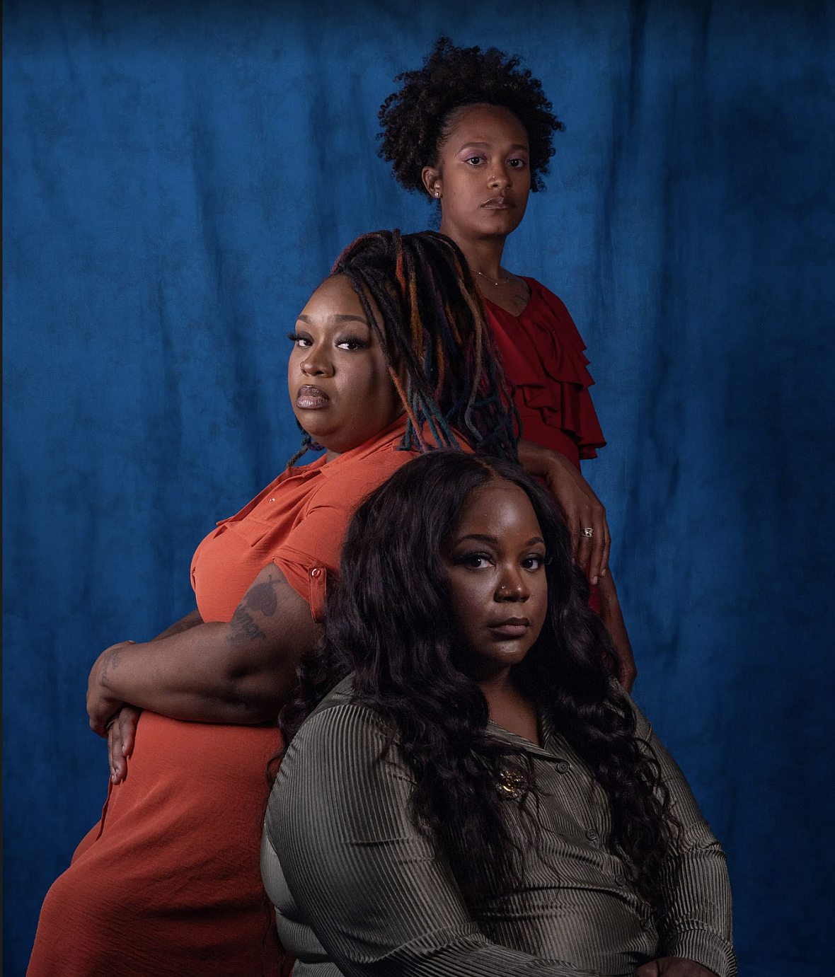 3 people in front of a blue backdrop