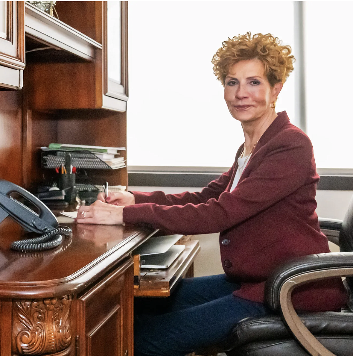 Person seated in front of a table