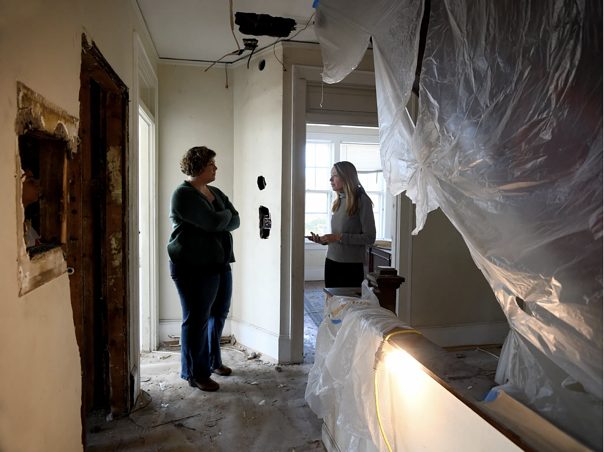 People in a house covered in tarp