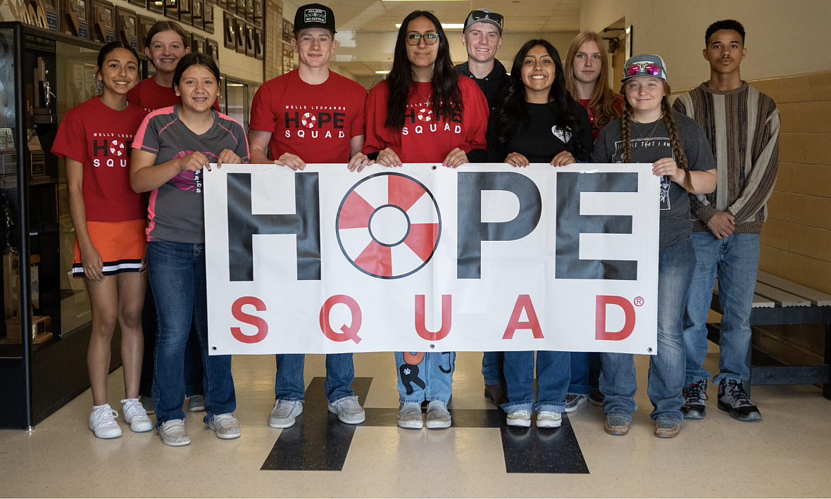 Group of people holding a 'Hope Squad' sign