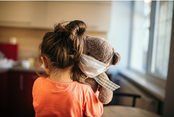 child holding a teddy bear