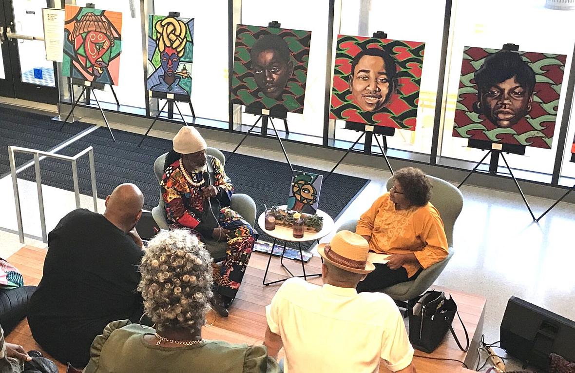 A gathering listening to a conversation in a cafe