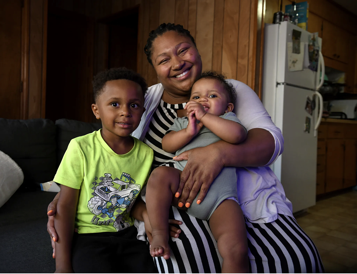 Person holding 2 children