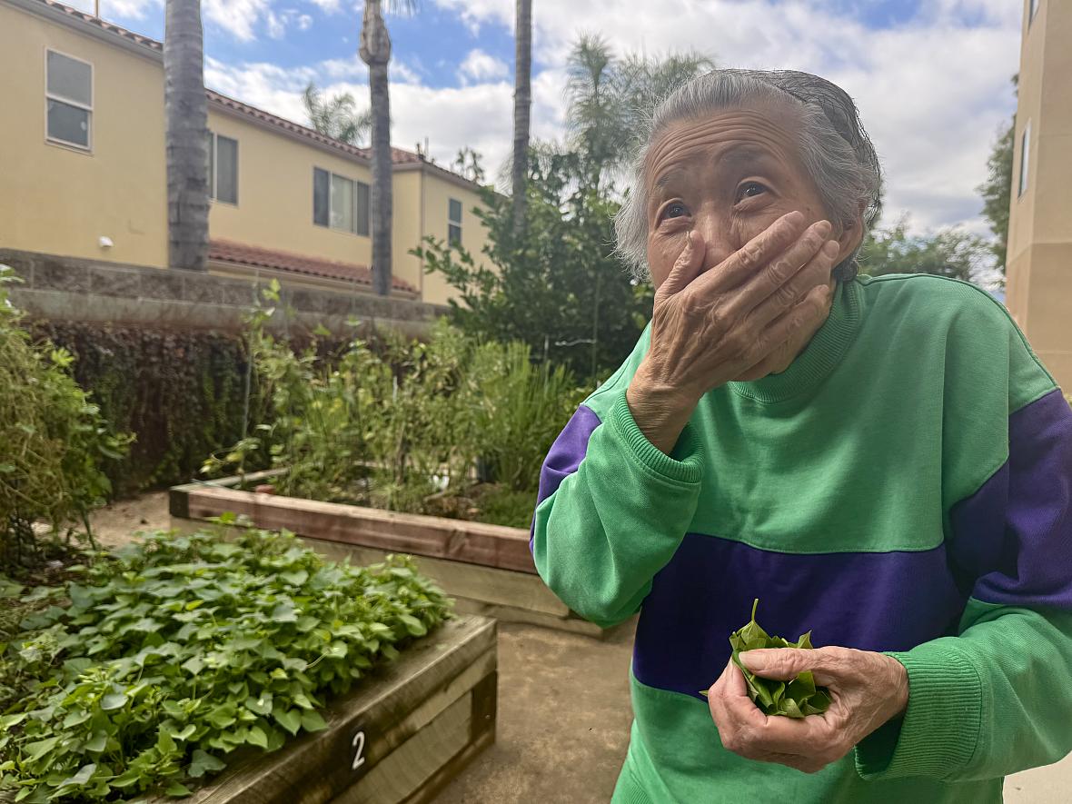 a woman with her hand to her mouth