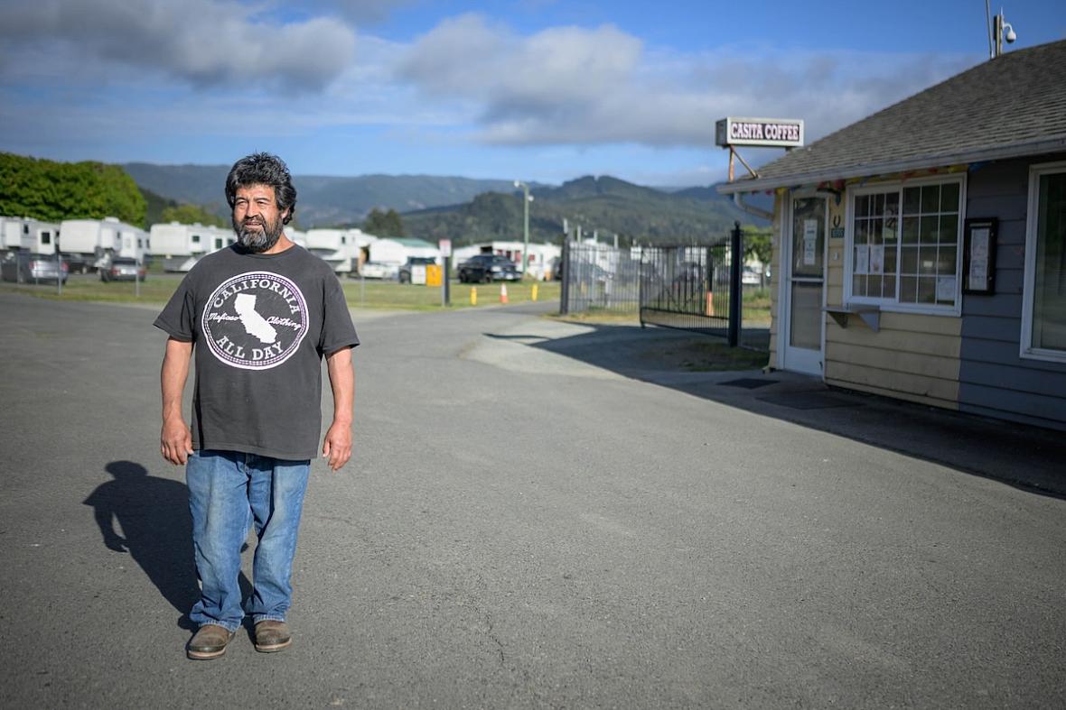 Person standing in front of the entrance to a trailer park 