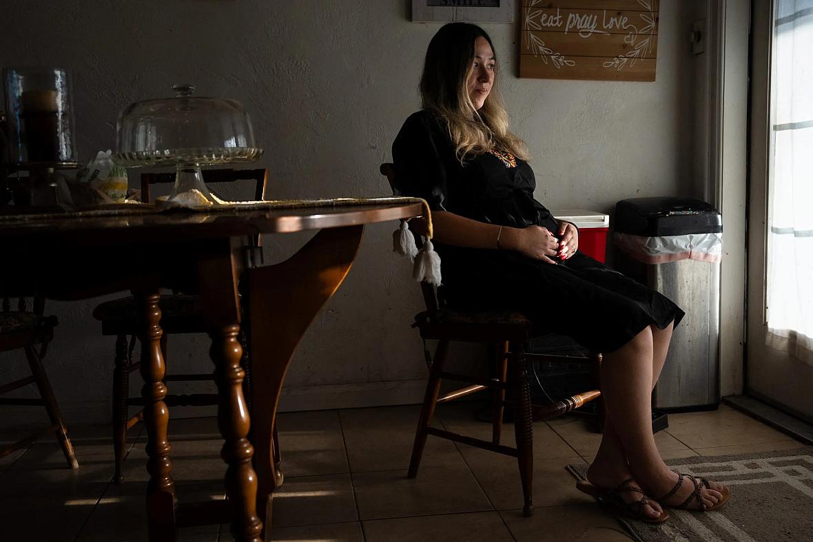 Person sitting on a chair by a window