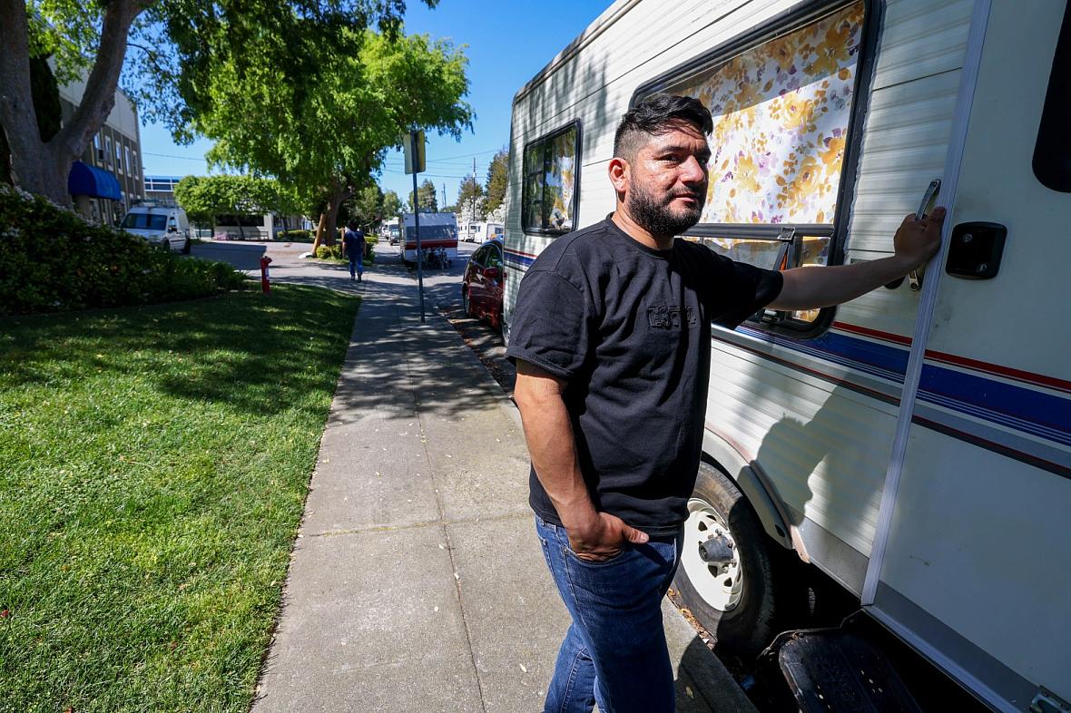 A person standing rear an RV