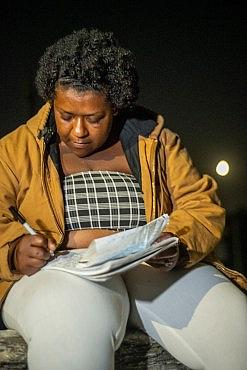 Person writing in a book