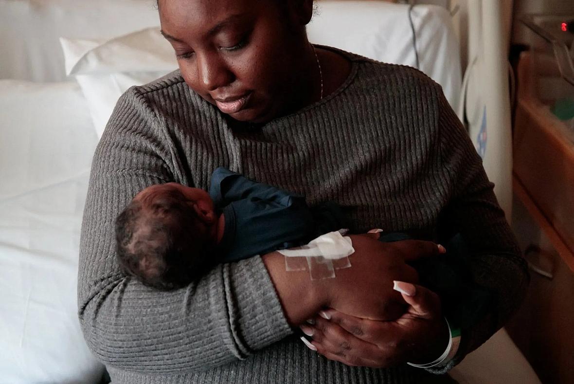 A woman holds her baby