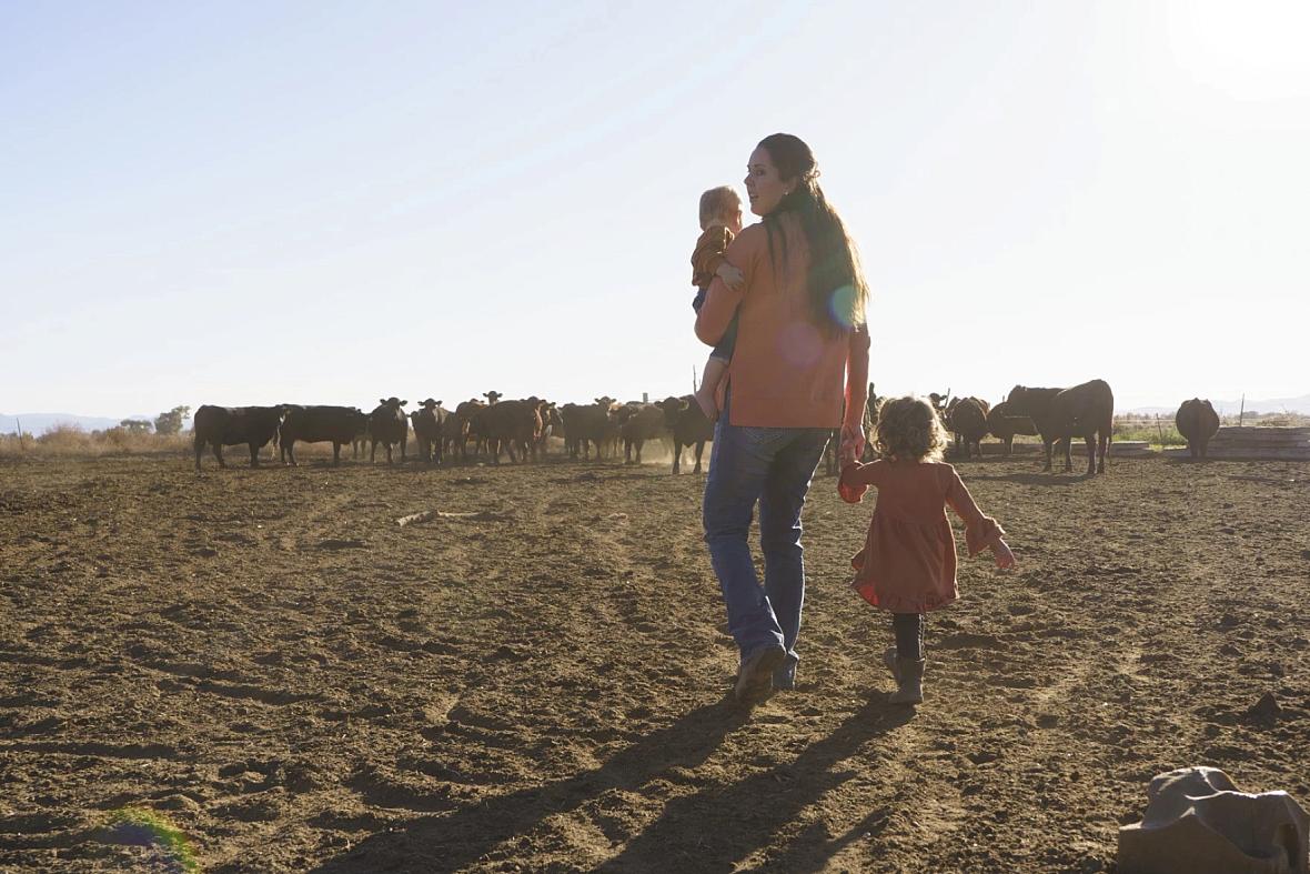 Image of a person walking with kids