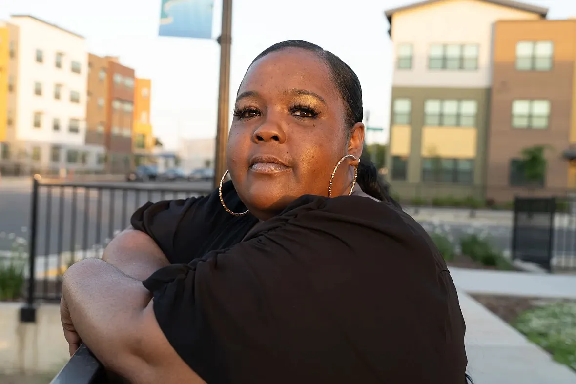 Person in black top standing on a railing