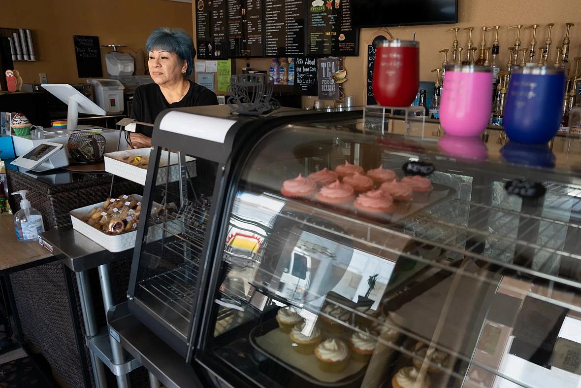 Person standing behind a bakery counter