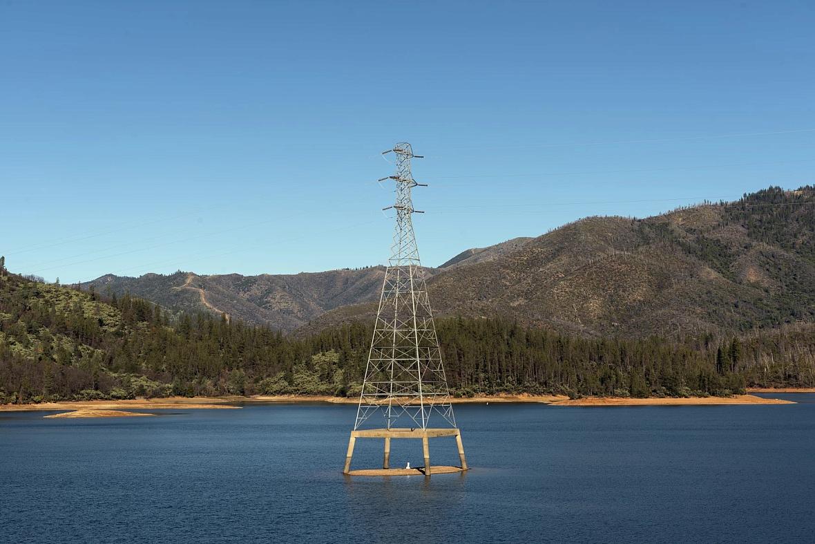 electric tower in the middle of a water body