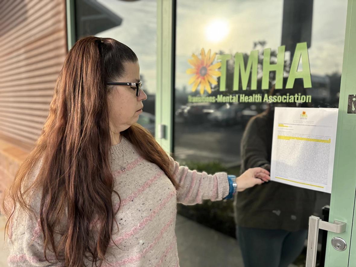 Person looking at a document stuck on a door