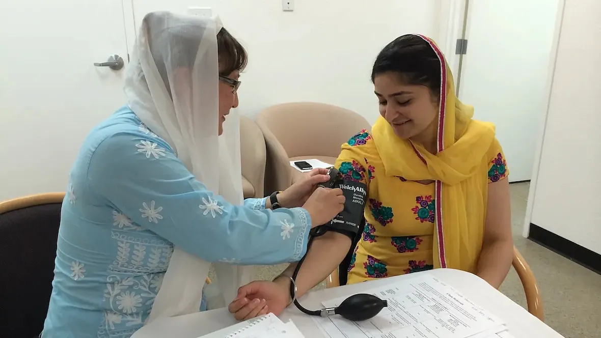 Person checking someone elses blood pressure