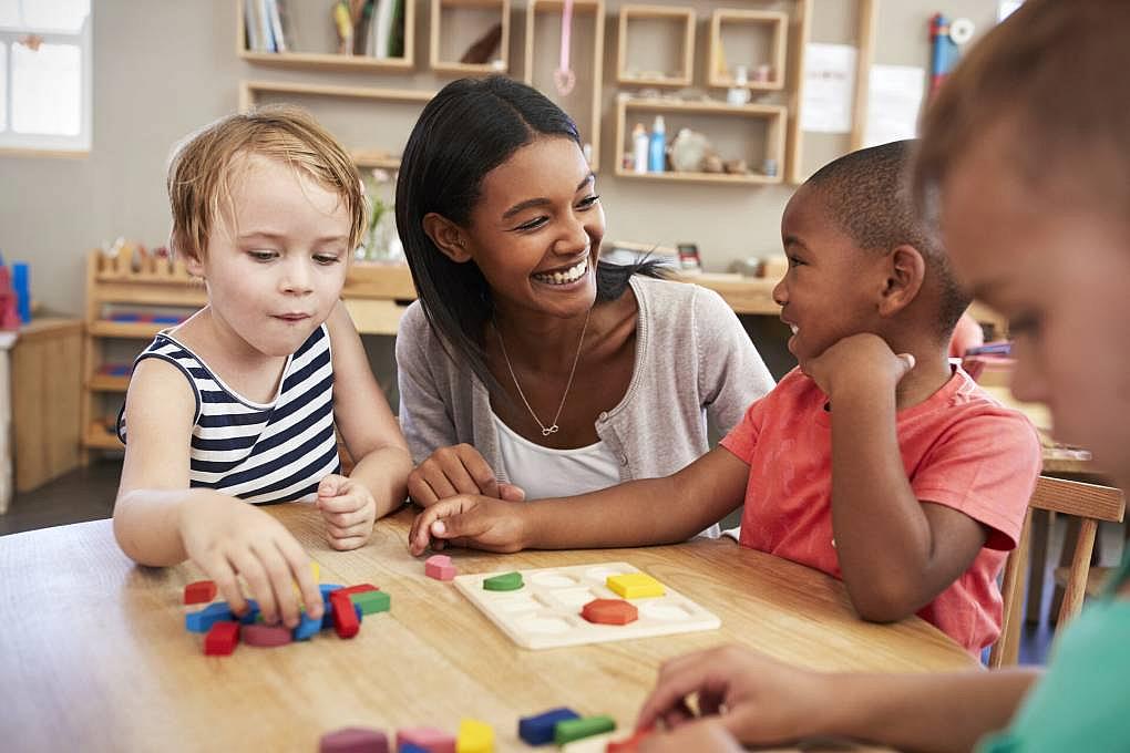 A teacher with 3 kindergarten children