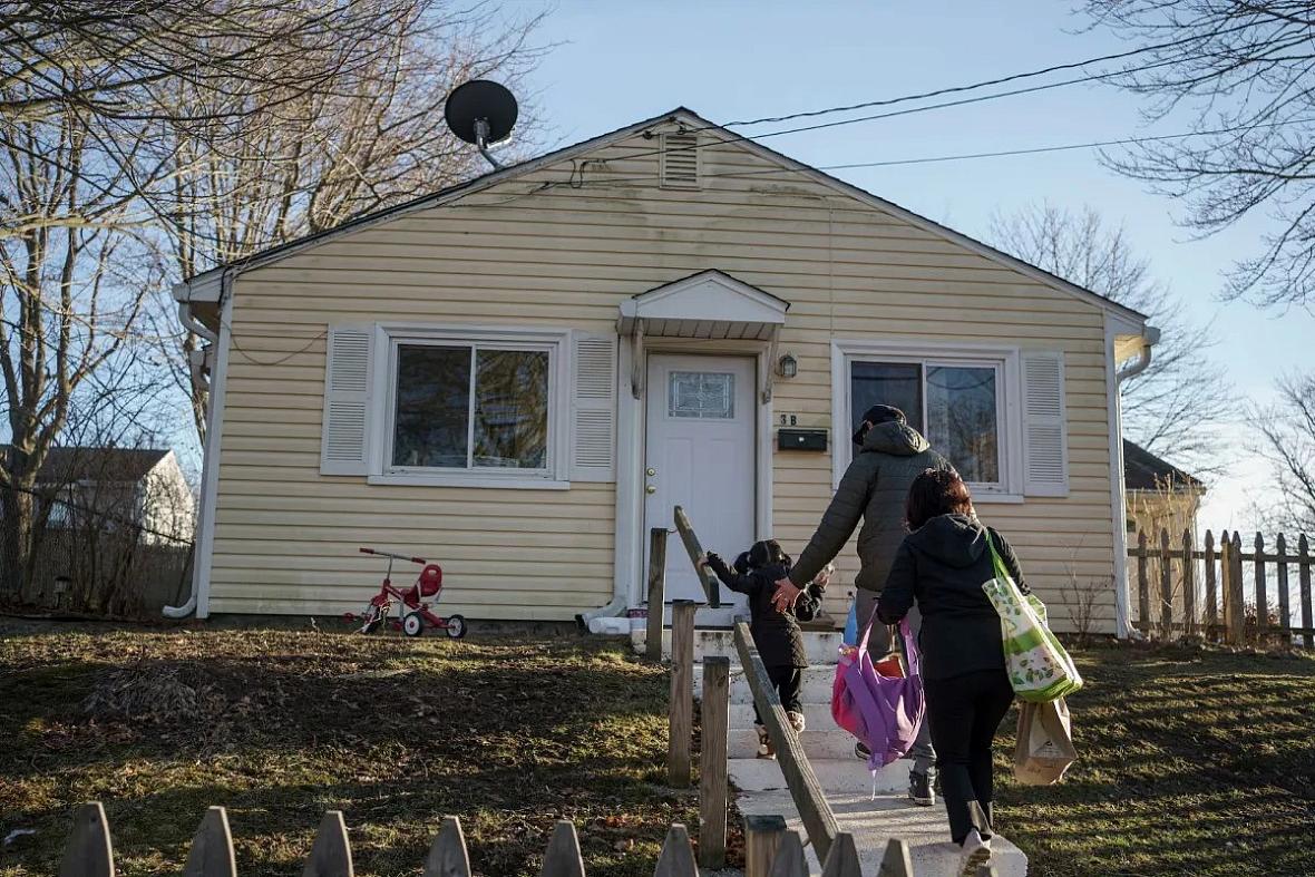 Image of a person walking into home