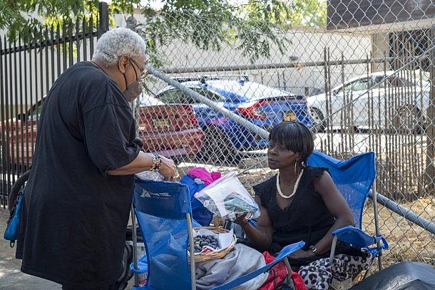 Person distributing hygiene supplies to another person