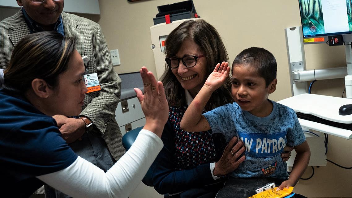 Six-year-old Abraham Gonzalez-Martinez celebrated a successful checkup at UCLA in November 2019 aloCortez, lefng with Dr. Manish Butte, back left, nurse Jackylout, and Dr. Maria Garcia-Lloret. (Credit: UCLA)