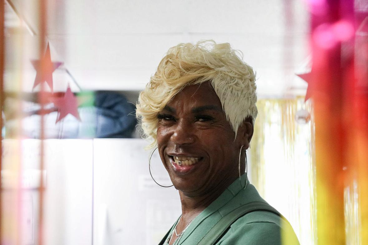 A person with golden hair and large earings