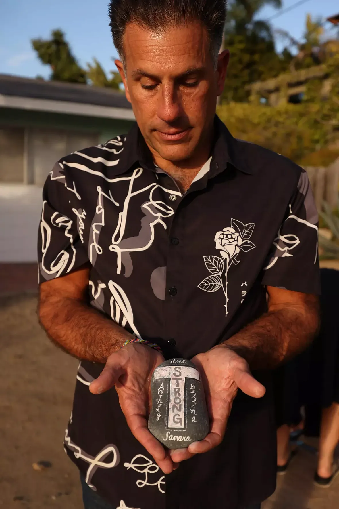 A person holding a stone