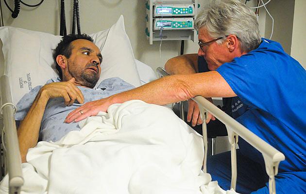 Dr. Chris Flynn listens to Alonso Camarena talk about the pain he’s experiencing during a recent visit to the Santa Barbara Cottage Hospital emergency room. Camarena, who does not have insurance, discovered he had cancer on his first visit to an emergency room two years ago. (Lara Cooper / Noozhawk photo) Dr. Chris Flynn listens to Alonso Camarena talk about the pain he’s experiencing during a recent visit to the Santa Barbara Cottage Hospital emergency room. Camarena, who does not have insurance, discovered he had cancer on his first visit to an emergency room two years ago. (Lara Cooper / Noozhawk photo)