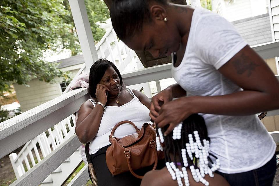 Theresa Johnson talked on the phone while her daughter, Ceecee, fixed the hair of her granddaughter Trinity. YOON S. BYUN/GLOBE STAFF