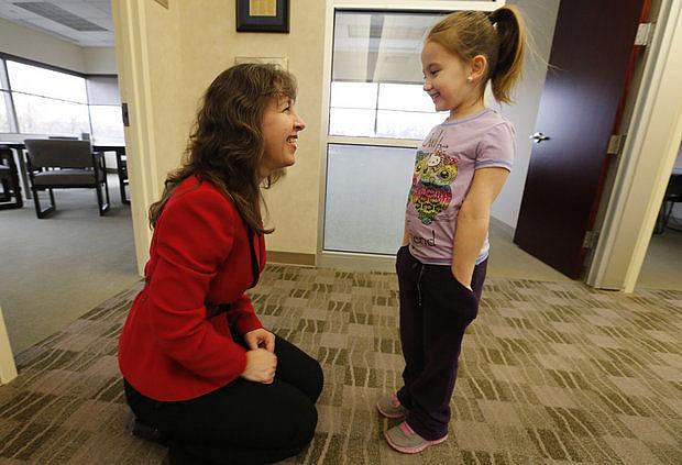 Pediatric neurologist Catherine Mazzola talks with one of her patients, Kayley Lancaster, whose parents have private insurance. The doctor does see Medicaid patients, but complained it took her staff nine months to complete the paperwork to get her on their rolls. (Robert Sciarrino)