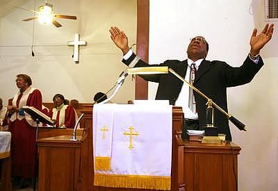 The Rev. Jeffrey M. Parker prays during a service at Community Reformed Church in the Sobrante Park neighborhood. The Rev. Jeffrey M. Parker prays during a service at Community Reformed Church in the Sobrante Park neighborhood.