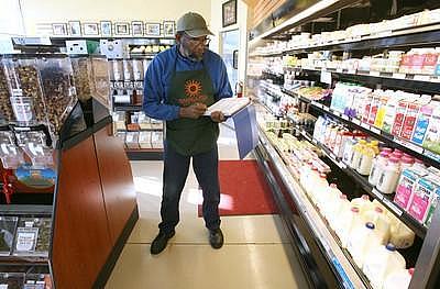 Dennis Terry takes inventory at the Mandela Food Cooperative on Seventh Street in west Oakland, Calif., on Wednesday.