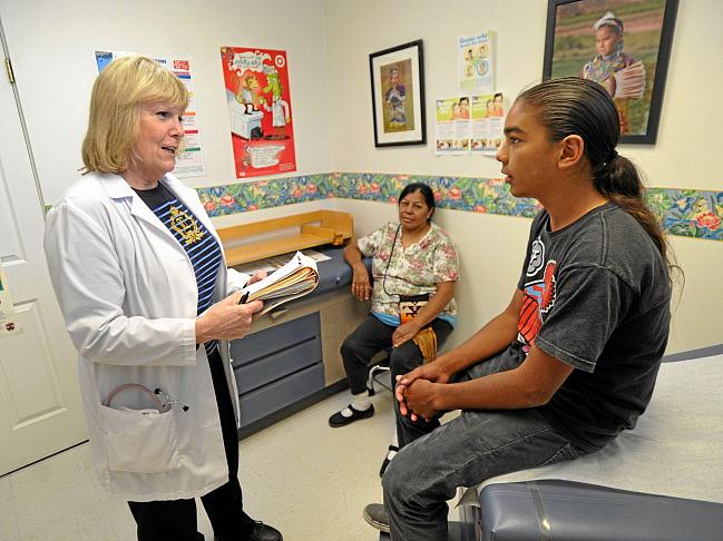 Co-founder and nurse practicioner, Debbie Bent, talks to Nash Helm, 13, and his mother, Sunshine, of La Mirada, during a physical examination at the American Indian Healing Center in Whittier on Wednesday May 15, 2013