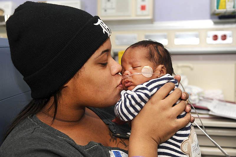 Alaina Gonville kisses her 3-month-old Brandon at the Neonatal Intensive Care Unit at Hutzel Women's Hospital in Detroit. Brandon was born premature through an emergency C-section. (Max Ortiz / The Detroit News)  