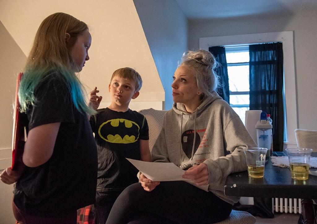 Tiana Warriner looks at a comic strip her daughter, Sophia, 9, drew, featuring their two new kittens as action heroes as her son, Jayce, 7, listens in. Warriner says her kids have really noticed a difference since she has gotten sober. “My kids tell me sometimes I need a meeting. Warriner said, “They tell me all the time, you’re not afraid anymore. They’re not worried. They’re not scared. They like their mom.” Tiana Warriner looks at a comic strip her daughter, Sophia, 9, drew, featuring their two new kittens as action heroes as her son