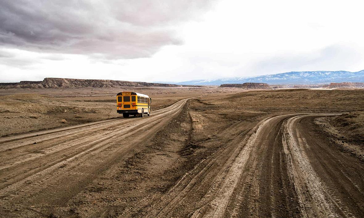 A school bus on the unpaved Indian service route 5010 near Sanostee. The seven-mile corridor connects as many as 2,500 resident