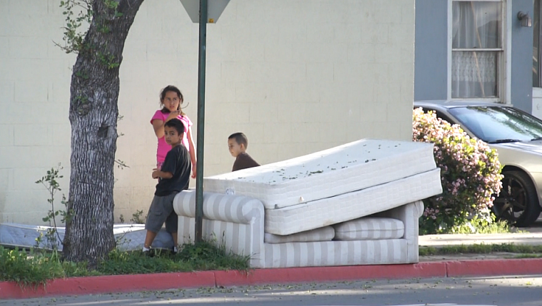 Children play on a street corner in central Santa Ana.