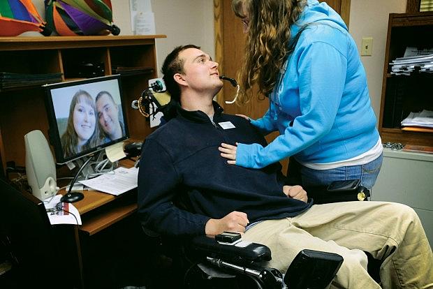 Michael Woods lost motor function in all of his limbs following a 2007 suicide attempt. He now travels to schools to speak on suicide prevention. He and his fiancee, Ashley Mead, spend a tender moment in his Billings office where he helps people with disabilities live independently. The couple plans to marry in June 2014.  