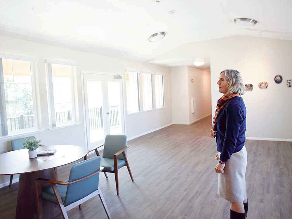 Elizabeth Wilson, director of housing development for MidPen Housing, looks over a common area of the new Van Buren apartment co